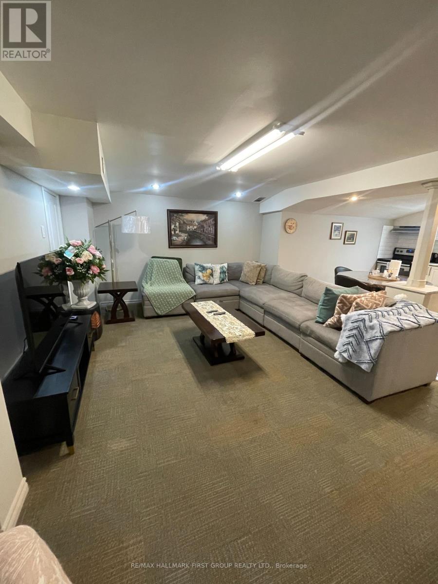 A living room with a grey couch, a coffee table, and a piano.
