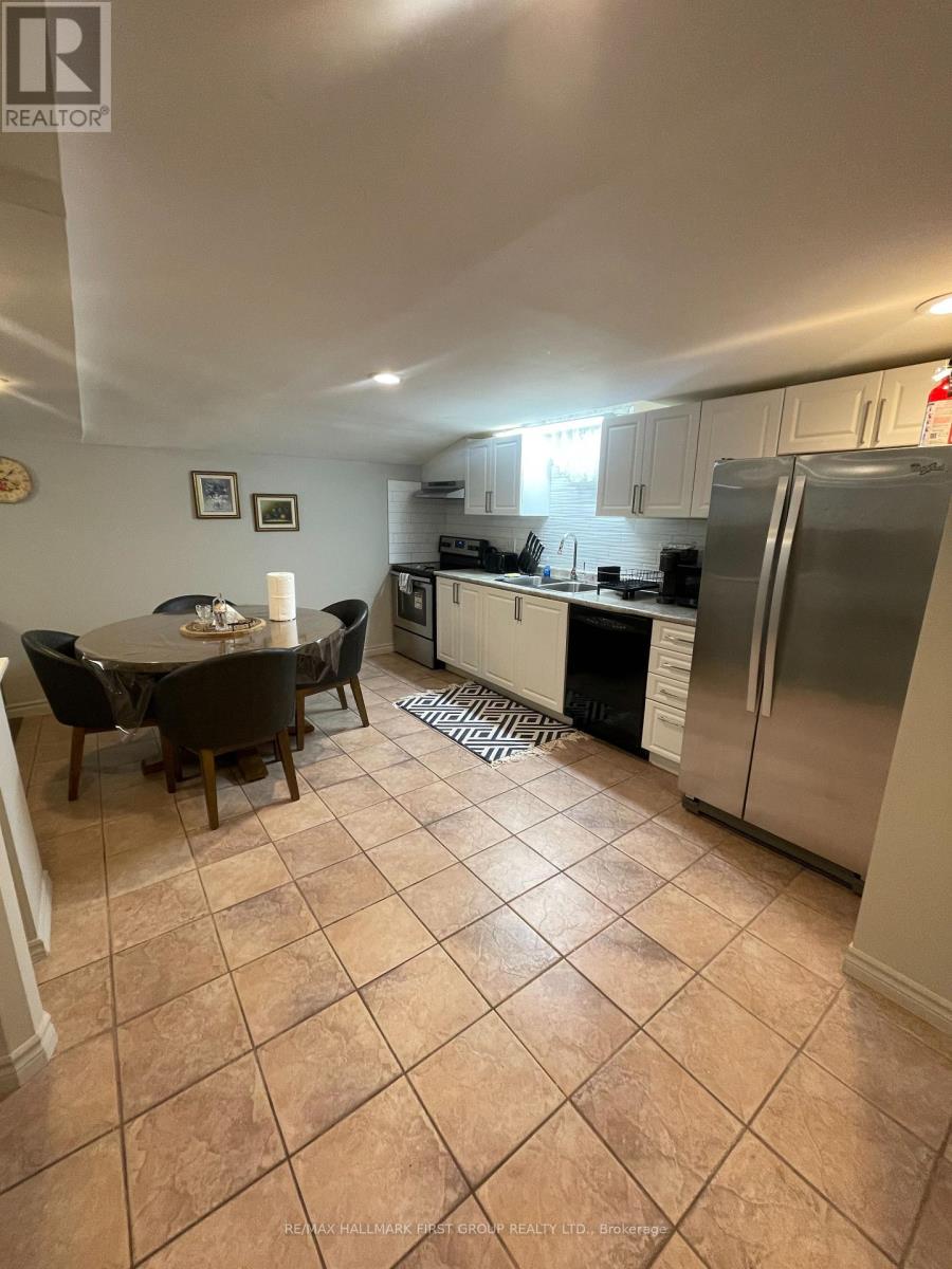 A kitchen with tile flooring and a dining table with chairs.