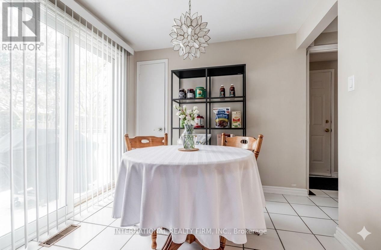 A dining room with a table set for four.