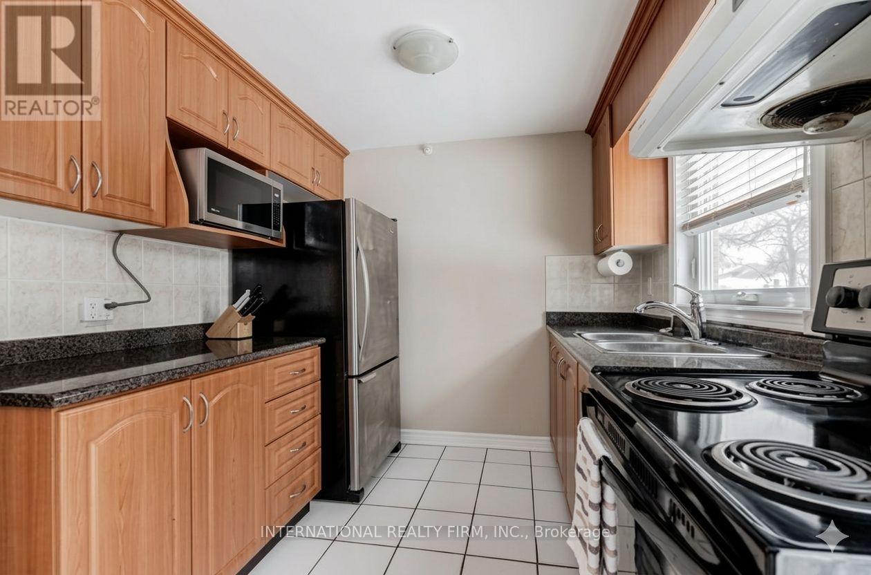 A kitchen with wooden cabinets and a black stove top.