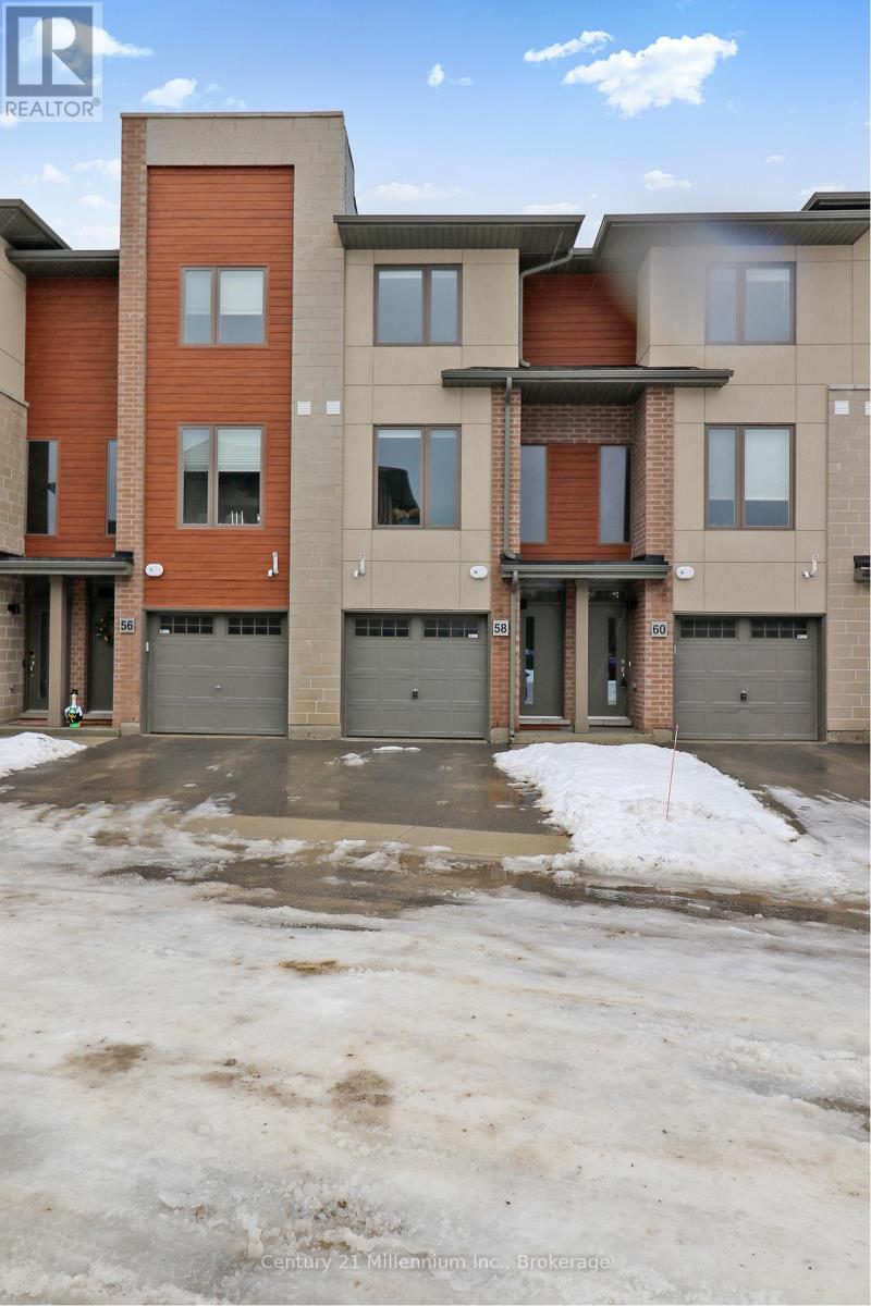 A building with a brown and beige facade has a snow-covered ground in front of it.
