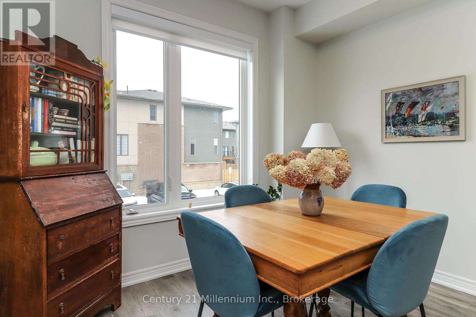 A dining room with a wooden table and blue chairs.