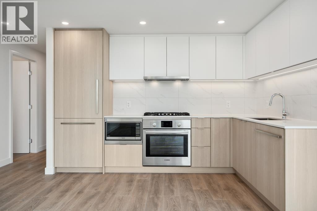 A modern kitchen with wooden cabinets and stainless steel appliances.