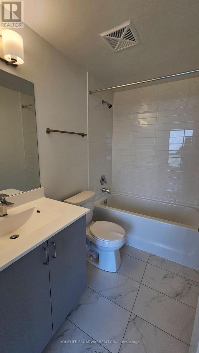 A white toilet sits in a bathroom next to a bathtub.