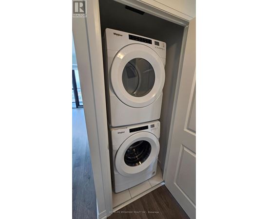 A white washer and dryer in a cabinet.