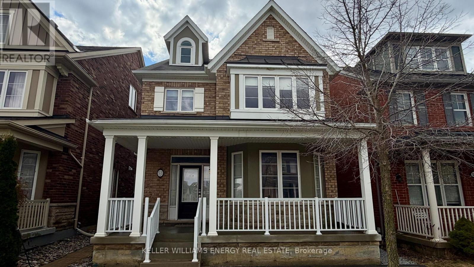 A house with a porch and a sign that says "REALTOR".