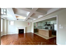 A spacious living room with hardwood floors and a fireplace.