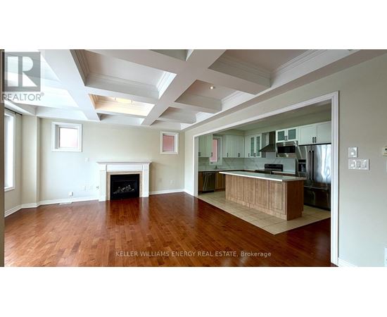 A spacious living room with hardwood floors and a fireplace.