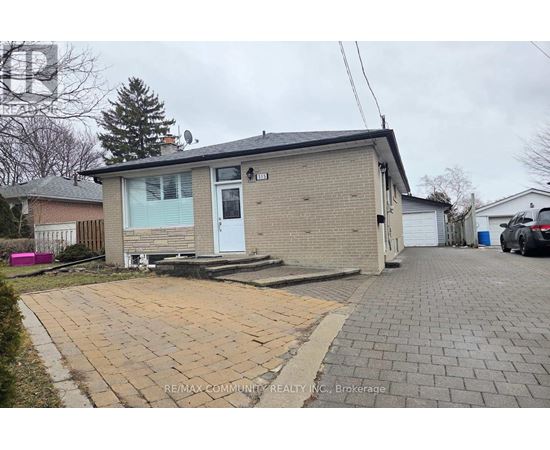 A small house with a driveway in front of it.