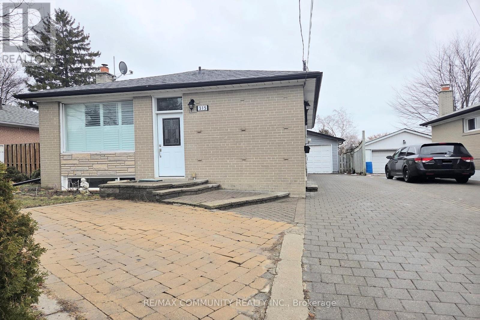 A house with a driveway in front of it.