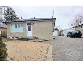 A house with a driveway in front of it.