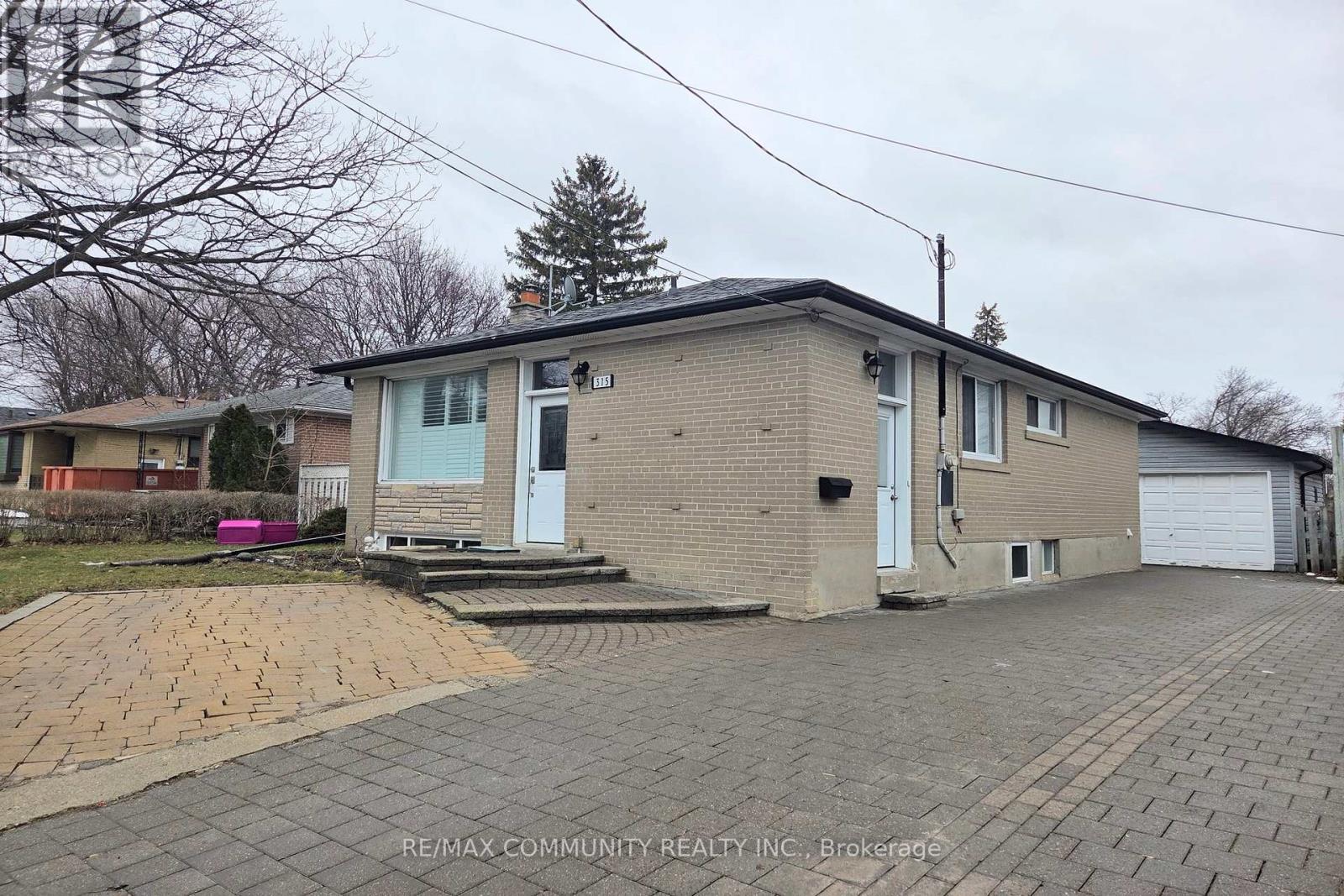 A house with a driveway in front of it.