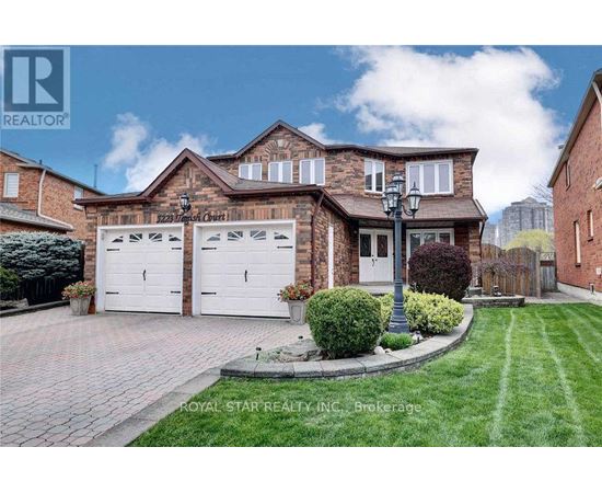 A house with a brick facade and a white garage door is for sale.