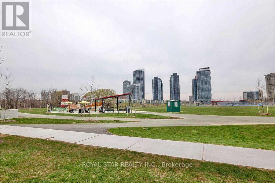 A park with a playground and a city skyline in the background.