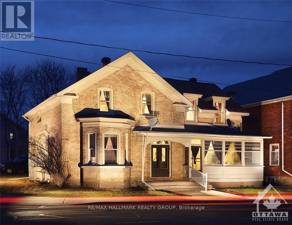 A house with a sign that says RE/MAX Hallmark Realty Group Brokerage.