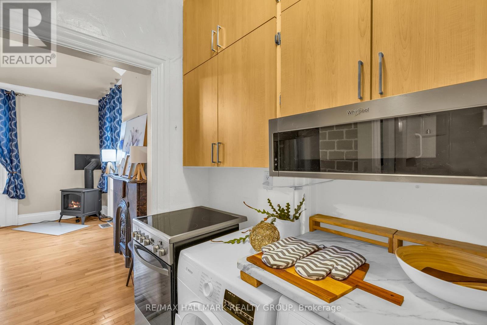 A kitchen with wooden cabinets and a stove top oven.