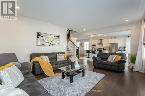 A living room with a grey couch and a coffee table.