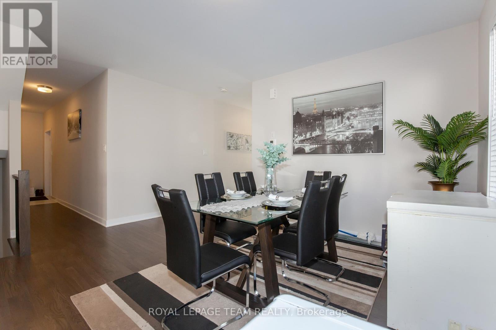 A dining room with a table set for four.