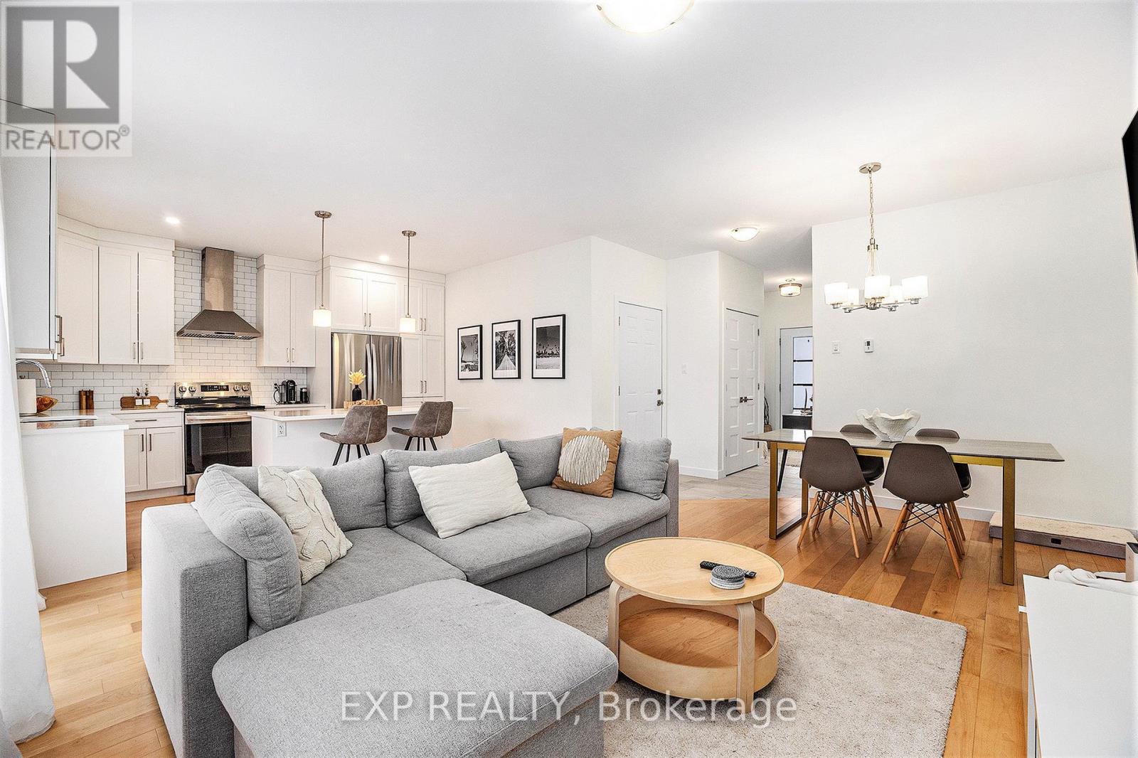 A modern living room with a grey couch and a wooden coffee table.