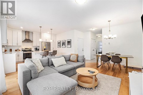 A modern living room with a grey couch and a wooden coffee table.