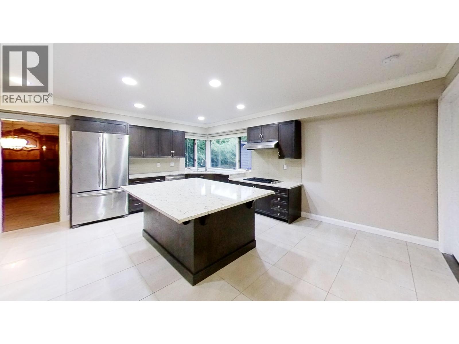 A modern kitchen with a large island in the center.