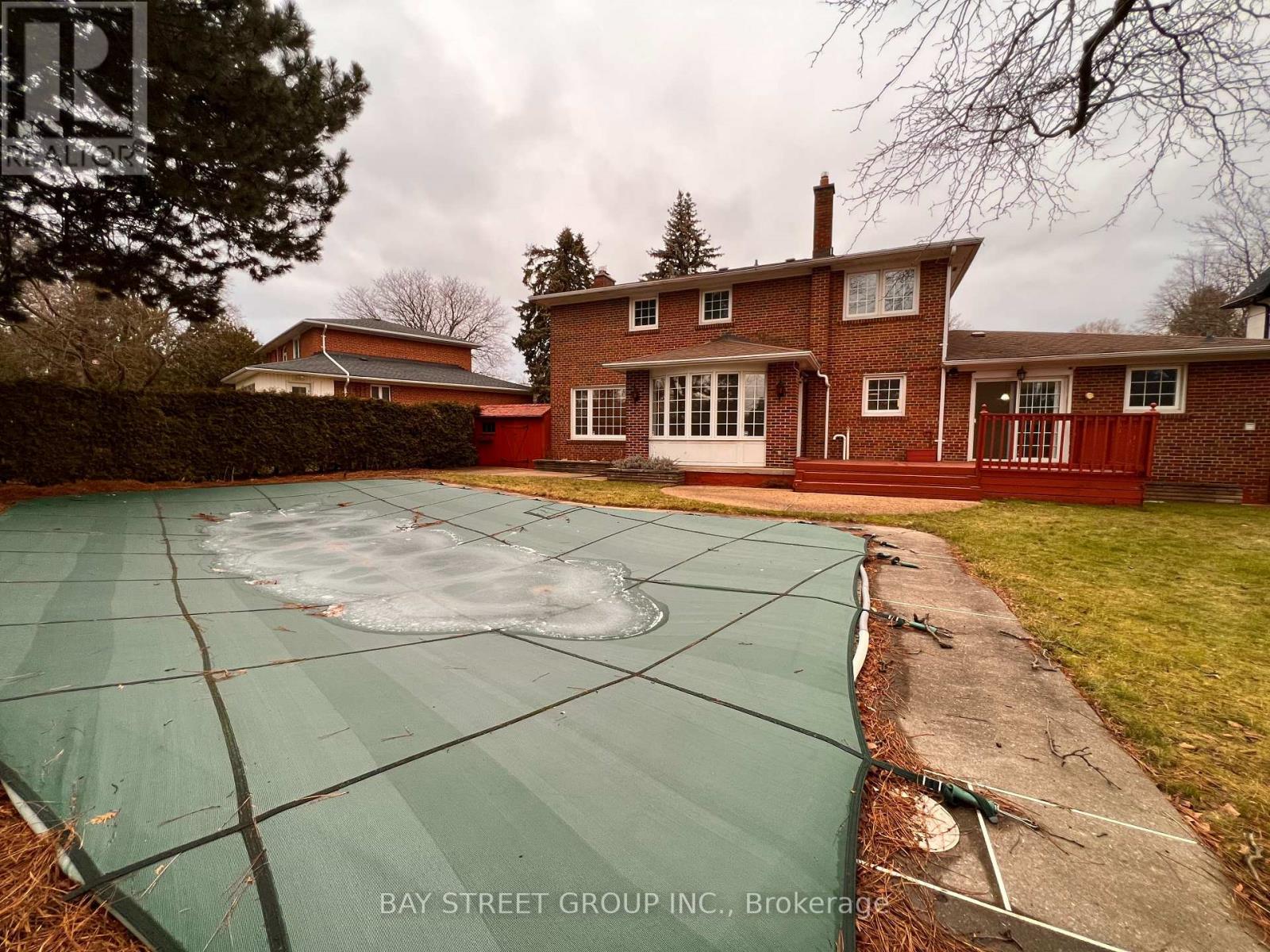 A Bay Street Group Inc. logo is on a photo of a backyard with a pool.