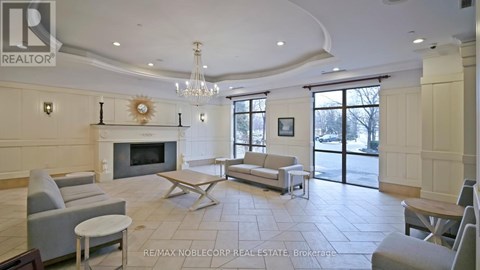 A living room with a fireplace and a chandelier.