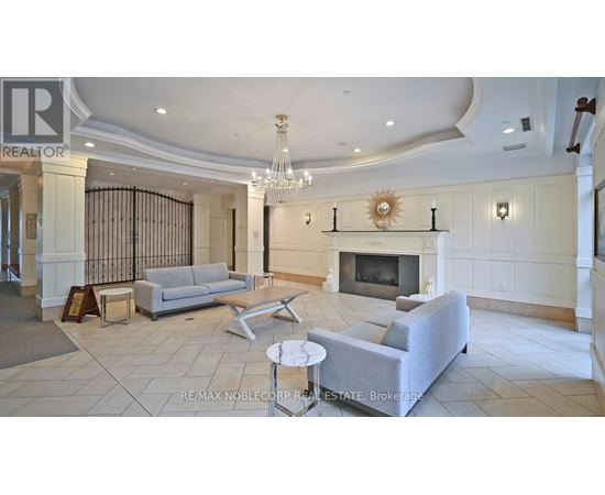 A living room with a fireplace and a chandelier.
