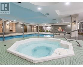 A hot tub in a room with a blue ceiling.