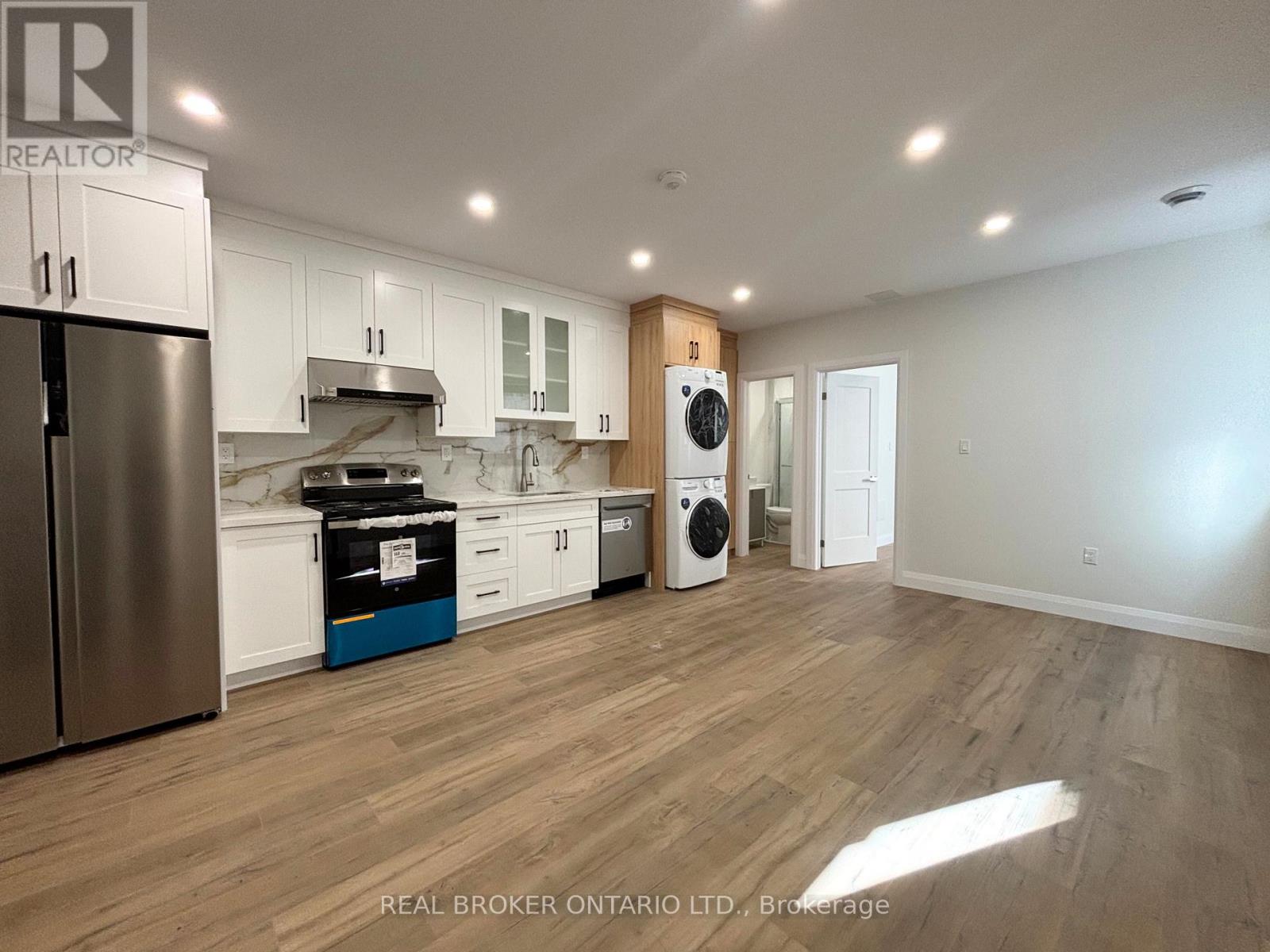 A kitchen with white cabinets and a wooden island.