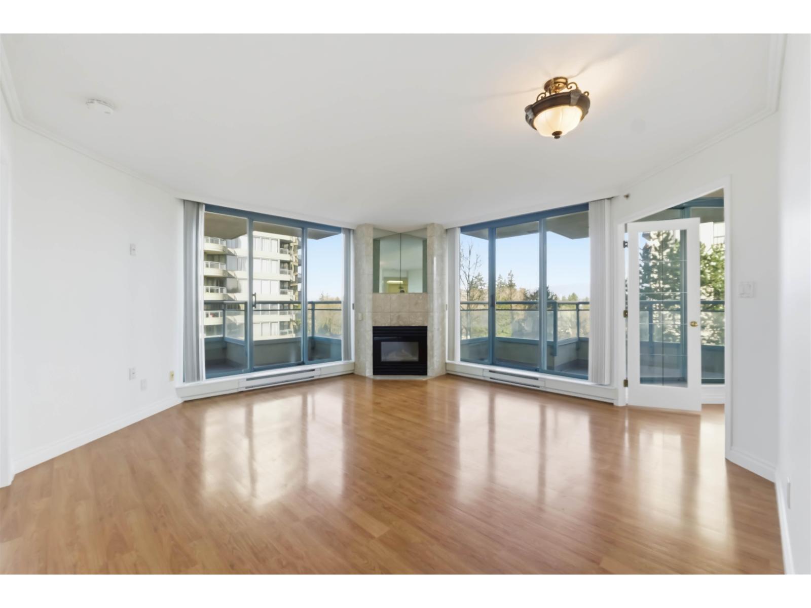 A living room with a fireplace and sliding glass doors.