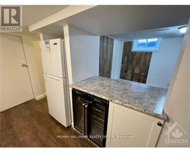 A kitchen with a white fridge and a granite counter top.