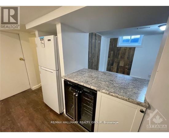 A kitchen with a white fridge and a granite counter top.
