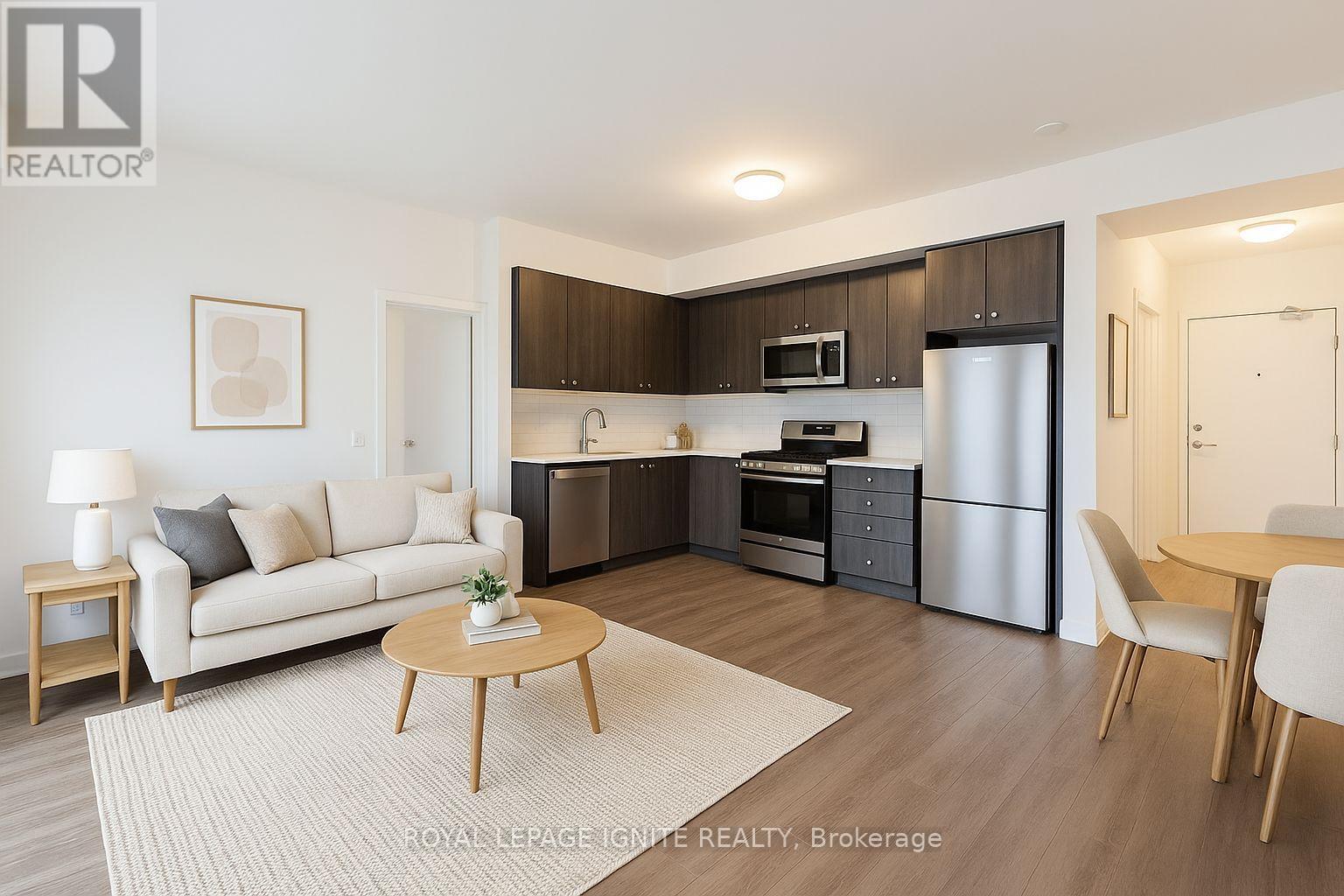 A modern kitchen with dark brown cabinets and stainless steel appliances.