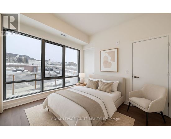 A bedroom with a large bed and a chair.