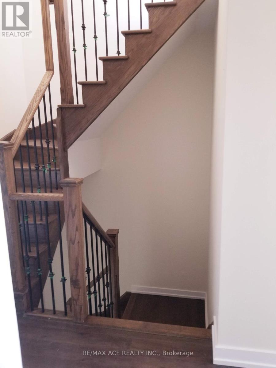 A wooden staircase with a metal railing.