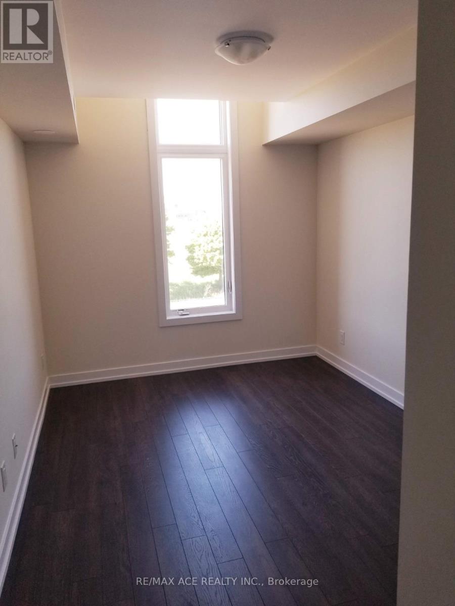 A room with a window and wooden flooring.