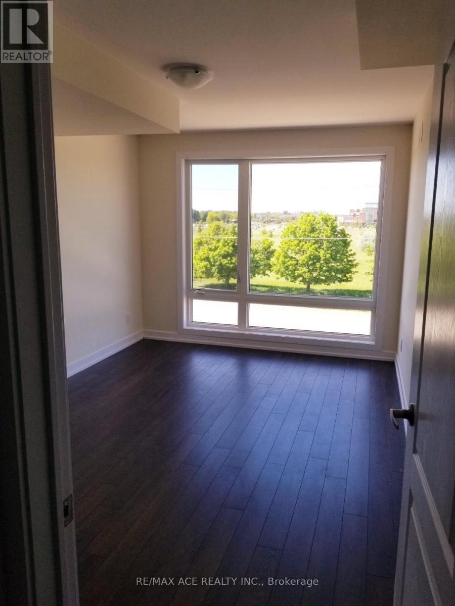 A room with a large window and wooden flooring.