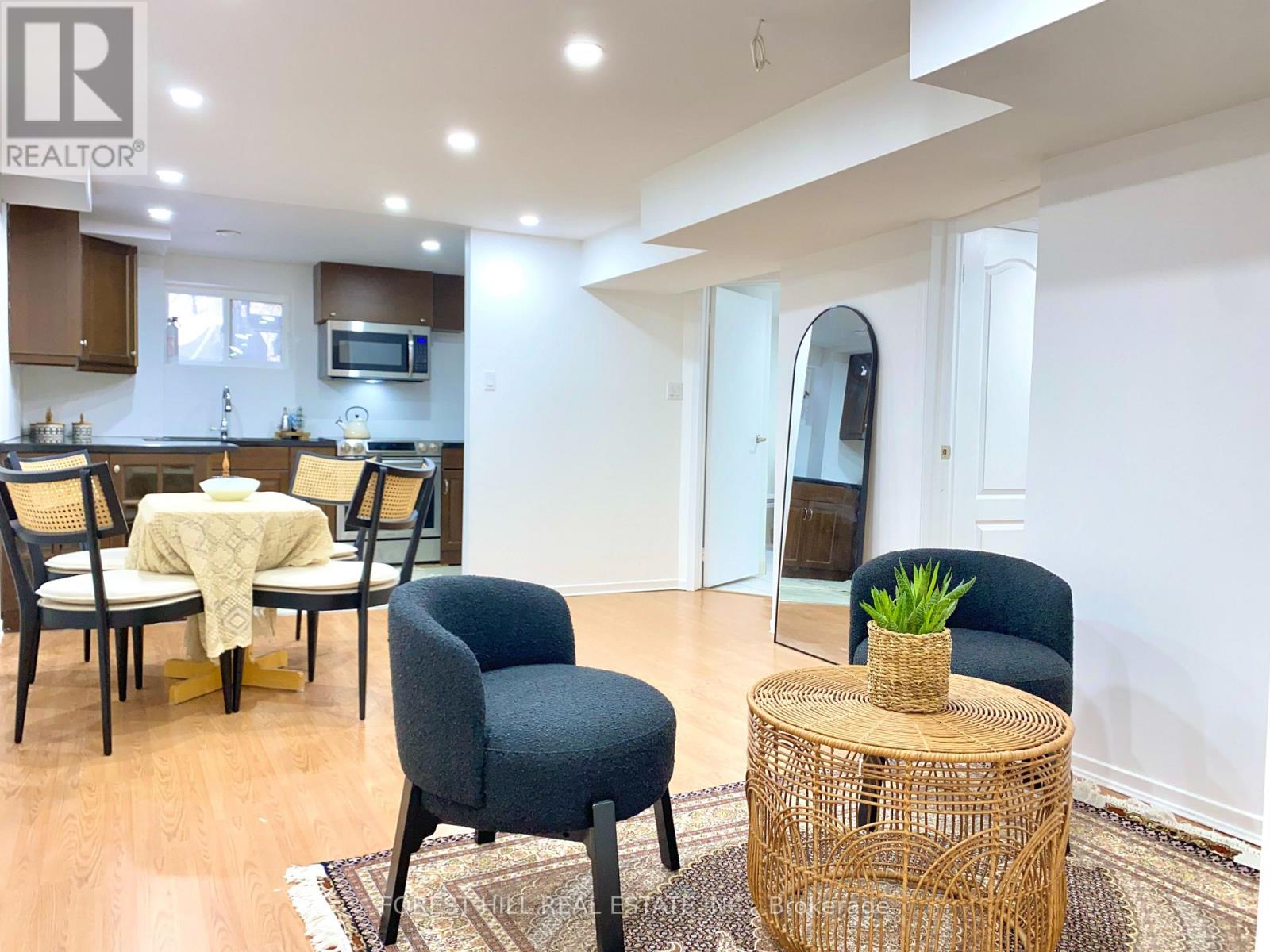 A living room with a dining table and chairs.