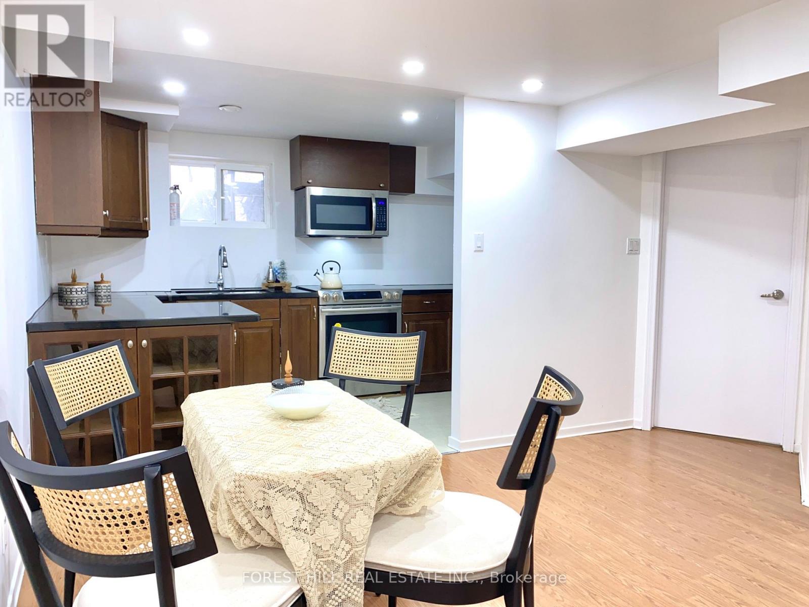 A kitchen with a table and chairs in the foreground.