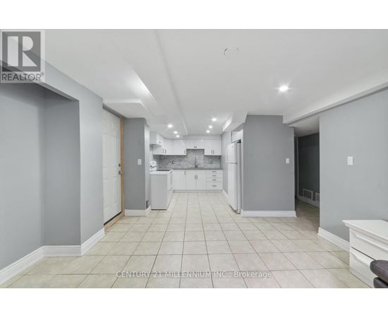 A spacious kitchen with white cabinets and appliances.