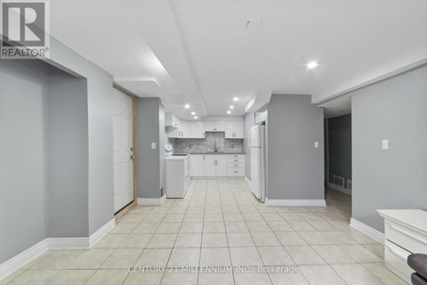 A spacious kitchen with white cabinets and appliances.
