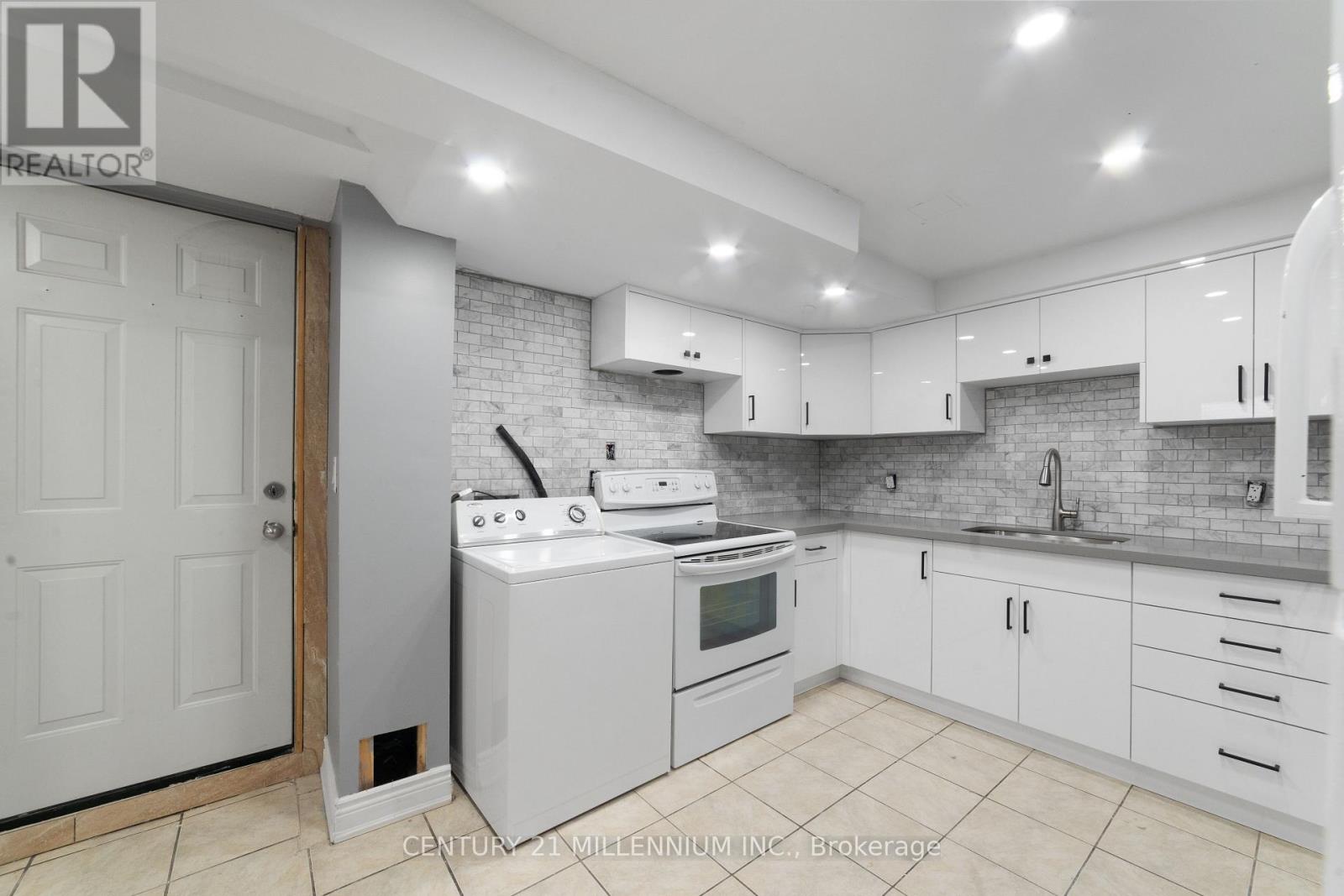 A kitchen with white appliances and cabinets.
