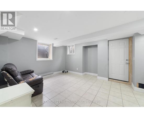 A room with a black leather chair and a white cabinet.