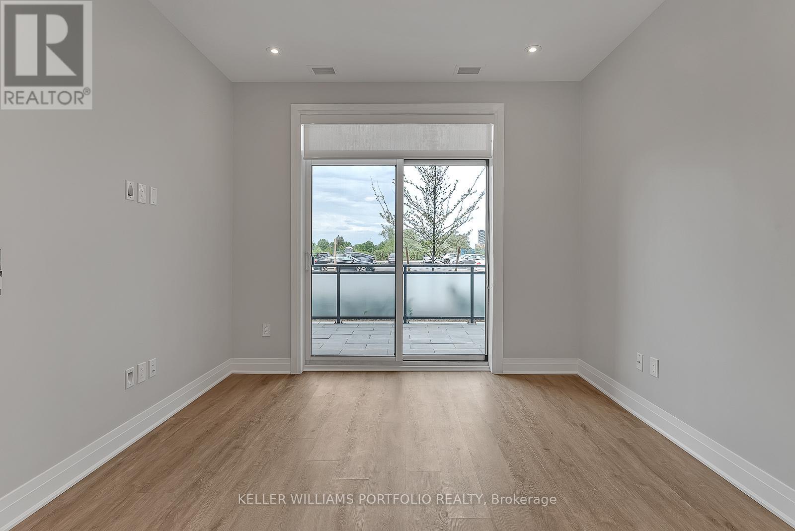 A spacious room with a view of the outdoors through a large window.