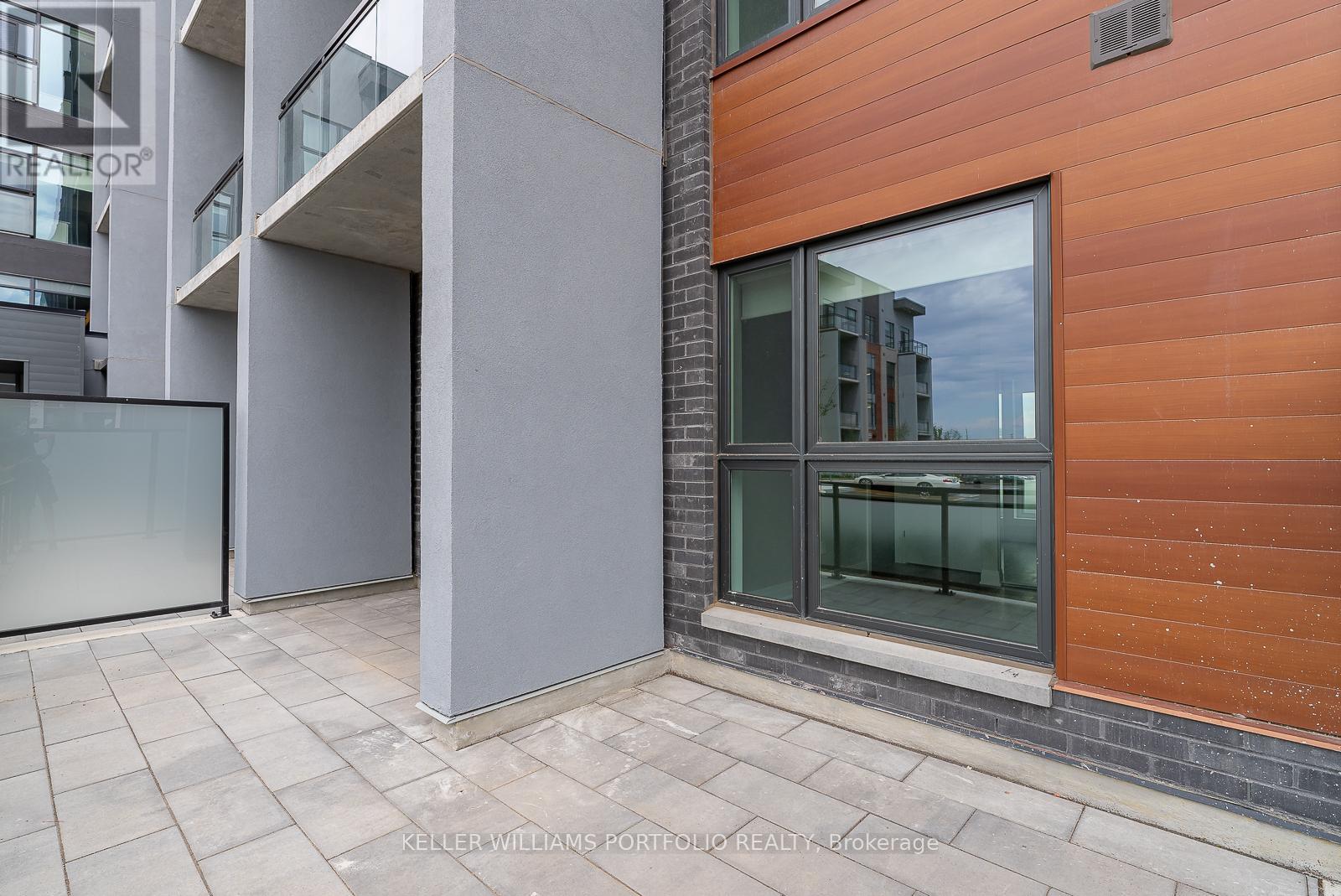 A modern building with a glass door and a wooden facade.
