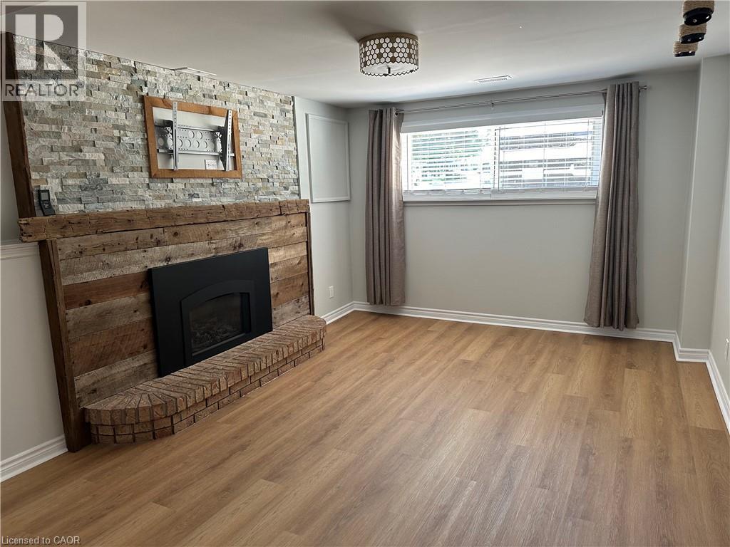 A room with a stone wall and a fireplace.