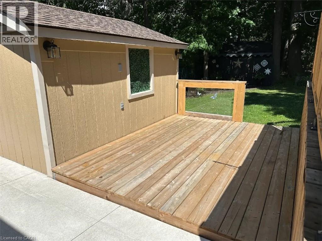 A wooden deck with a small building attached to it.