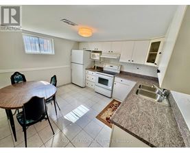 A kitchen with a table and chairs in it.