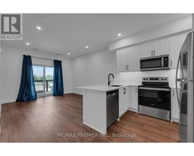A modern kitchen with white cabinets and stainless steel appliances.